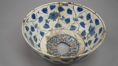Lot 1726 - A Persian blue and white dish with the fluted...