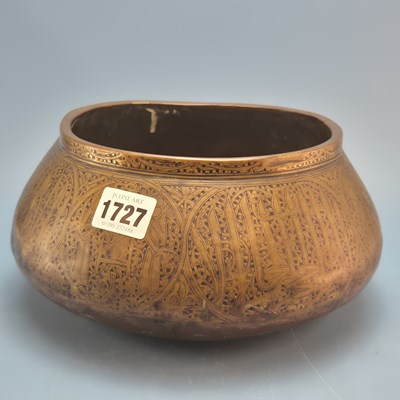 Lot 1727 - An early Persian brass bowl, the exterior...