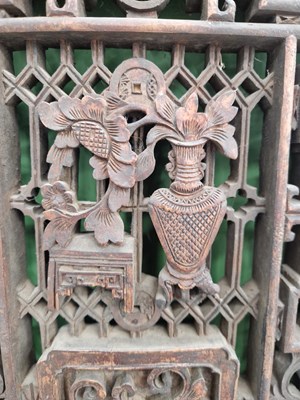 Lot 25 - A pair of carved Oriental panels, together...