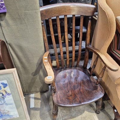 Lot 211 - An antique slat back elm seat kitchen armchair
