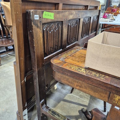 Lot 217 - An oak double bed frame with carved linen fold...