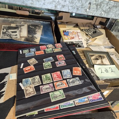 Lot 229 - Two boxes of vintage photographs, stamps, and...