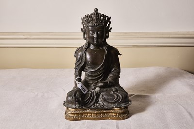 Lot 138 - An early Chinese bronze figure of a seated...