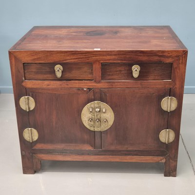 Lot 105 - An antique Chinese rosewood cabinet, with two...
