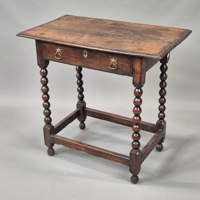 Lot 423 - An early carved oak one-drawer table, bobbin...
