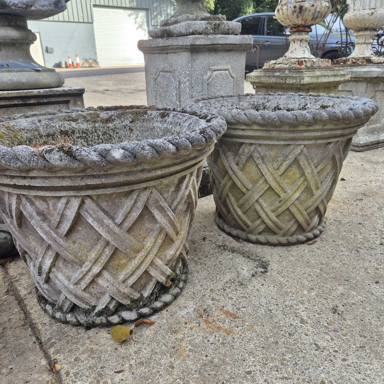 Lot 391 - A pair of Haddonstone weathered composite