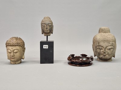 Lot 312 - A group of three Oriental diety heads, two in...