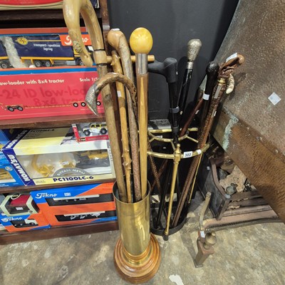Lot 302 - A brass stick stand with  walking sticks,...