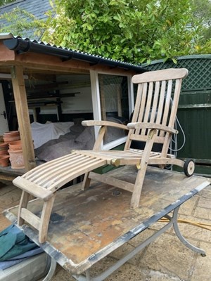 Lot 411 - A teak steamer chair with fitted cushions