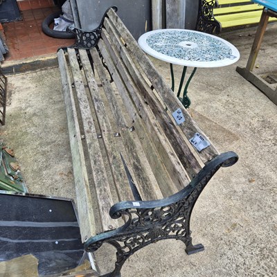 Lot 418 - A garden bench and a small circular patio table.
