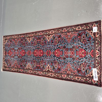 Lot 910 - A Persian runner of traditional design, 201 x...
