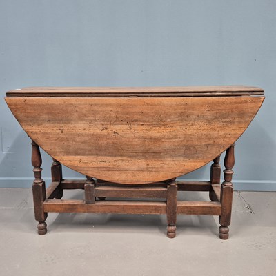 Lot 448 - A Georgian fruitwood drop leaf gateleg table,...