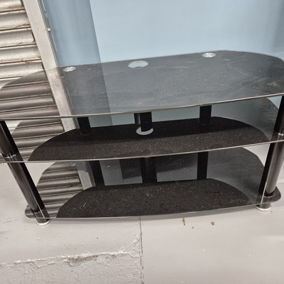 Lot 737 - A flat screen TV with glass stand