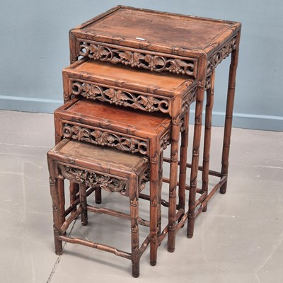 Lot 942 - A nest of four Chinese hardwood occasional...