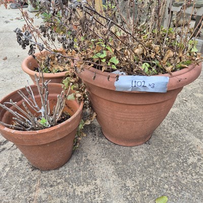 Lot 1102 - Two terracotta garden urns and one other