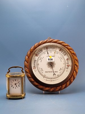 Lot 936 - An oak rope framed aneroid barometer, the...