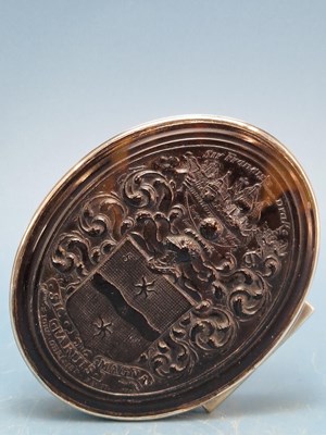 Lot 1318 - A tortoiseshell lidded oval box carved in...