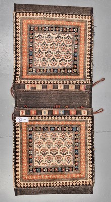 Lot 580 - An antique Persian large saddle bag/cushion,...