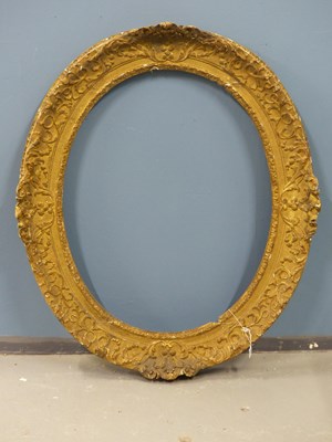 Lot 1205 - An 18th Century carved oval giltwood frame,...