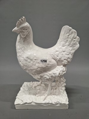Lot 1256 - A white glazed pottery figure of a rooster...