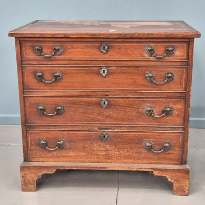 Lot 552 - A Georgian inlaid padouk chest, four long...
