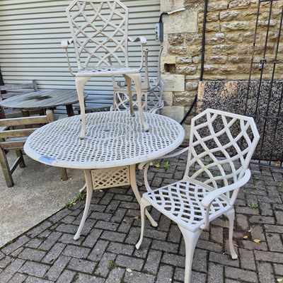 Lot 1107 - A large alloy patio table and four matching...