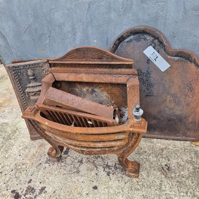 Lot 1112 - A cast iron fire back and a firegrate plus a...
