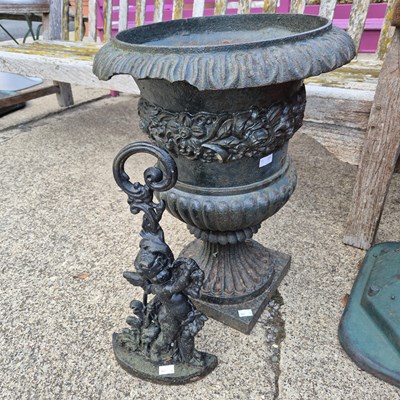 Lot 1120 - A cast iron garden urn and a cast iron door...