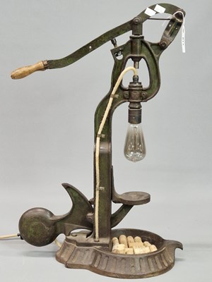 Lot 814 - An iron bottle corking press mounted as an...