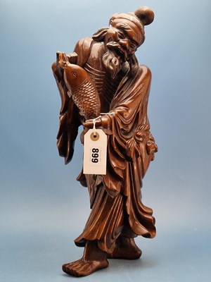 Lot 899 - A Chinese carved hardwood figure of a...