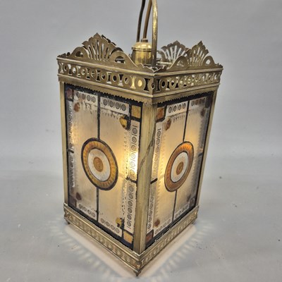 Lot 1043 - A late Victorian brass-framed stained glass...