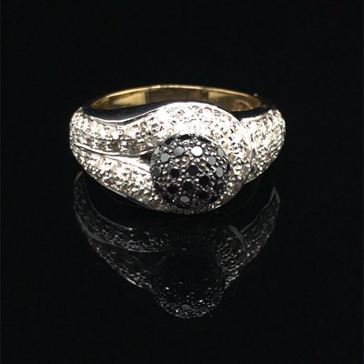 Lot 1243 - A contemporary black and white diamond ring....