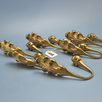 Lot 558 - Four pairs of gilt brass acanthus form curtain...
