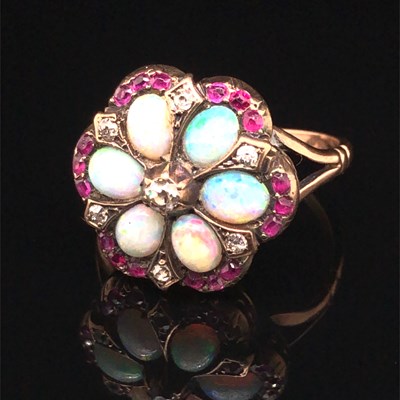 Lot 1244 - An antique opal, ruby and diamond cluster ring....