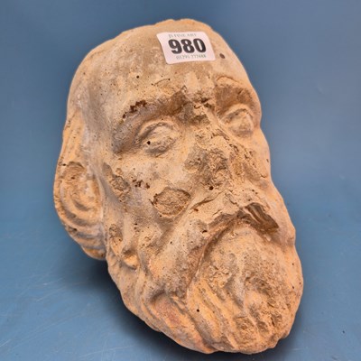Lot 980 - A cast composition stone head of a bearded man....