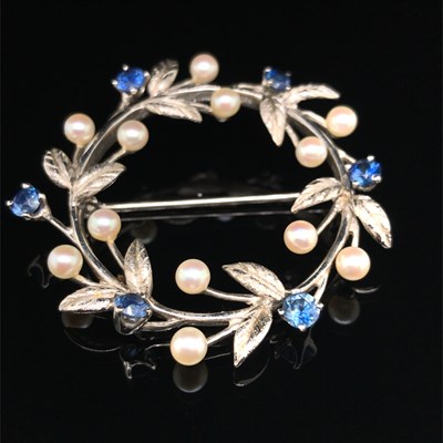 Lot 1248 - A sapphire and diamond wreath brooch....