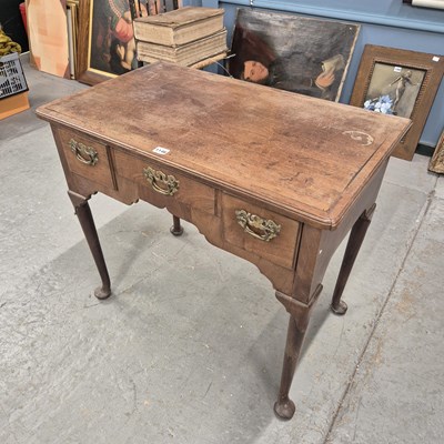 Lot 1146 - A Georgian mahogany lowboy, three apron...