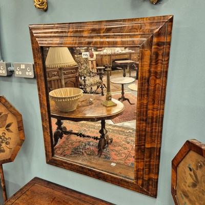 Lot 715a - A fine oyster veneered cushion frame wall mirror