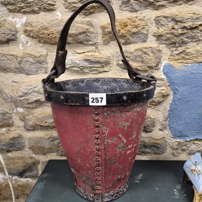 Lot 257 - A 19th century red painted leather fire bucket...