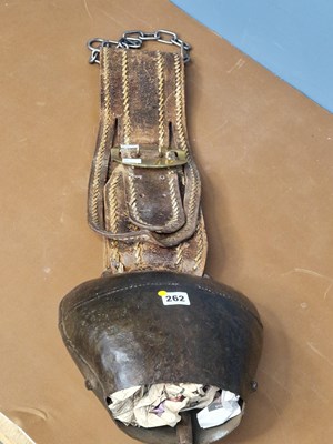Lot 262 - A massive iron cow bell on a leather strap...