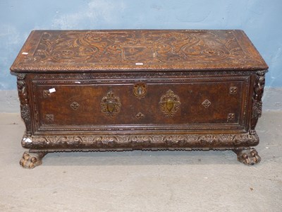 Lot 269 - An 18th century walnut cassone, the lid carved...