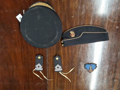 Lot 305 - An officer's cap, a forage cap, a naval badge...