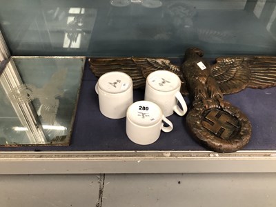 Lot 280 - A bronzed eagle and swastika applique, a...