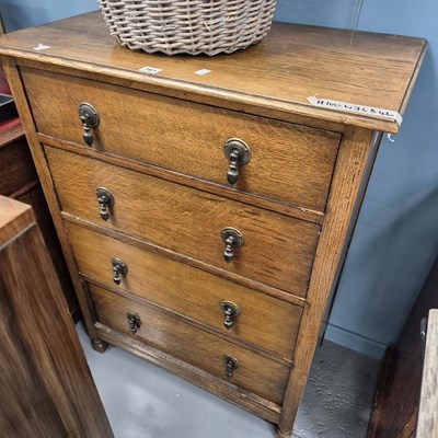 Lot 761 - A small oak four drawer chest.