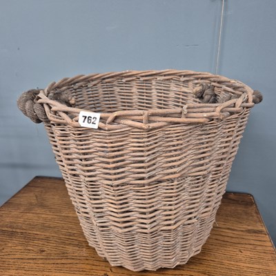 Lot 762 - A small log basket.