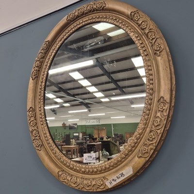 Lot 770 - A large 19th-century oval wall mirror.