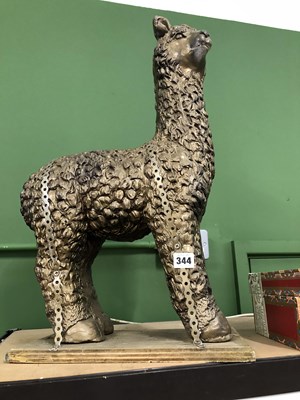 Lot 344 - A gilded composition model of a Llama together...