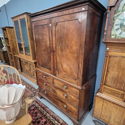 Lot 783 - A George III mahogany linen press with twin...