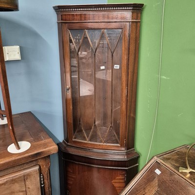 Lot 801 - A corner cabinet.