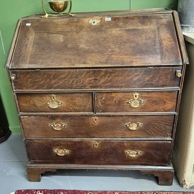 Lot 803 - An 18th century oak bureau.